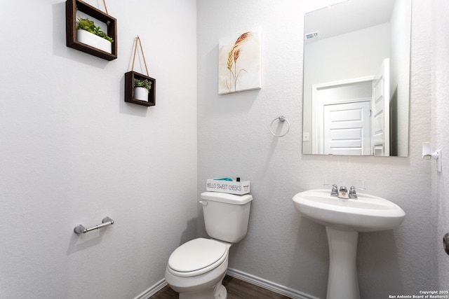 bathroom featuring sink, toilet, and hardwood / wood-style floors