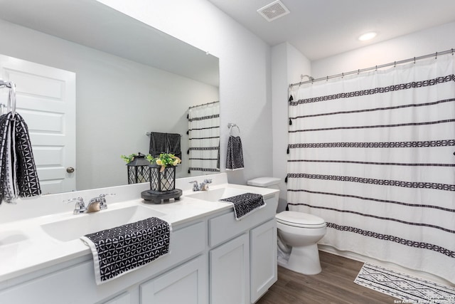 bathroom featuring hardwood / wood-style flooring, vanity, and toilet