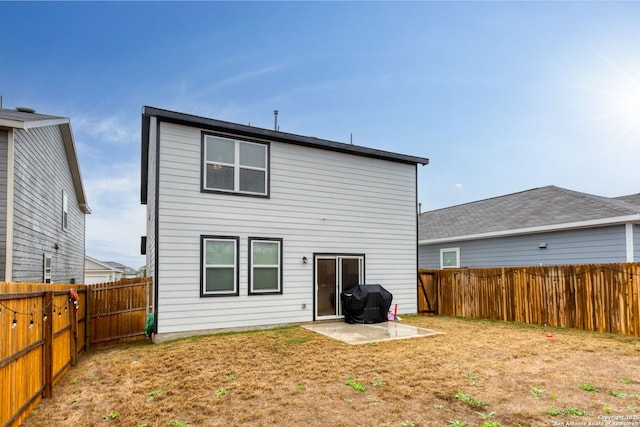 back of house featuring a yard and a patio area