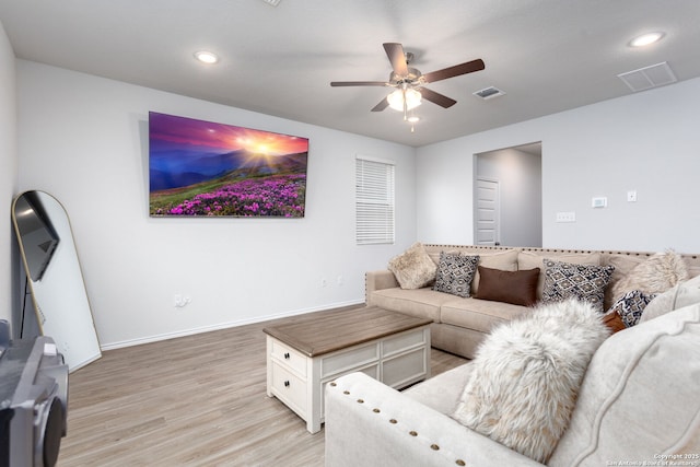 living room with ceiling fan and light wood-type flooring