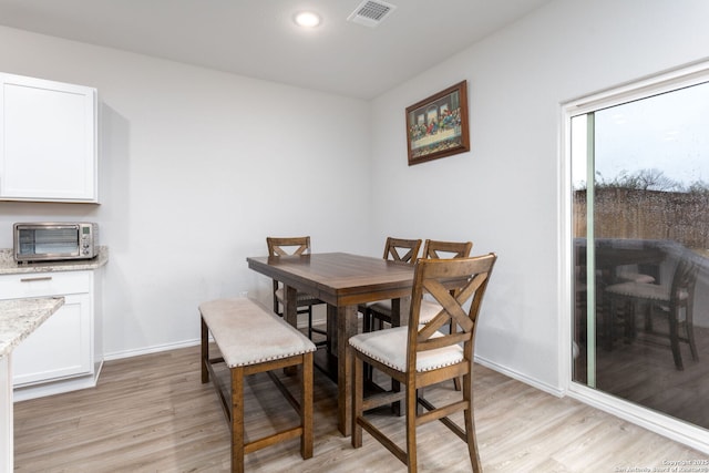 dining area with light wood-type flooring