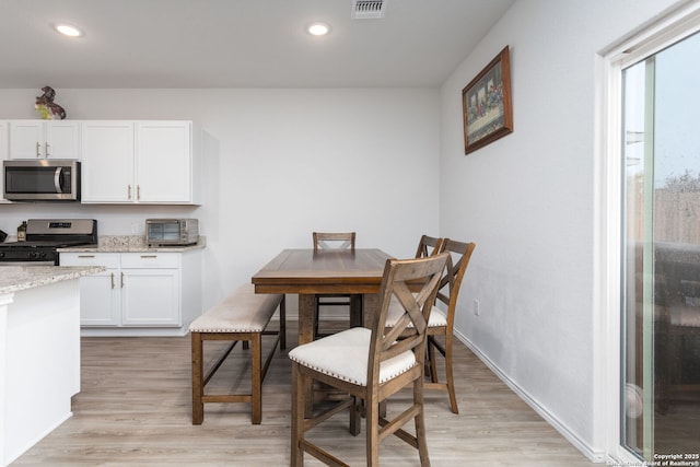 dining area featuring light wood-type flooring