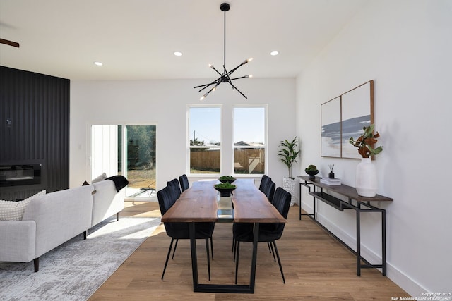 dining area with hardwood / wood-style flooring and a notable chandelier