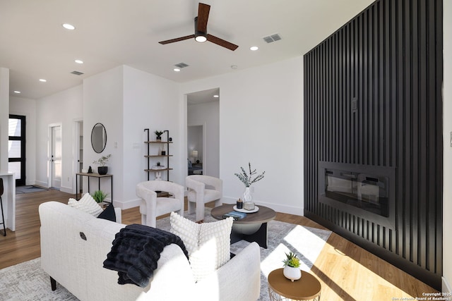 living room featuring ceiling fan and wood-type flooring