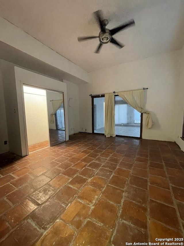 unfurnished living room with ceiling fan