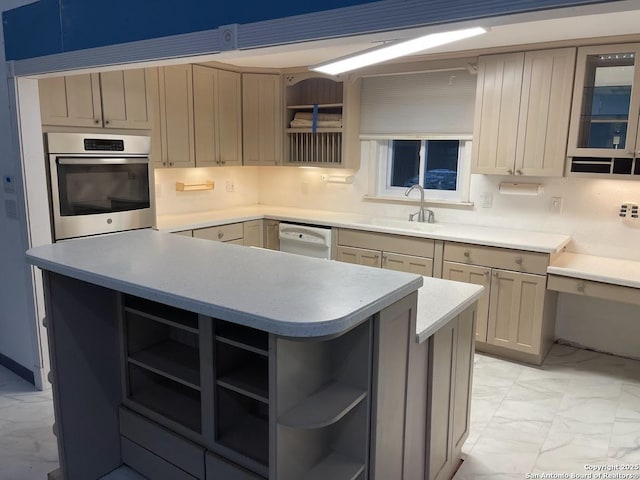 kitchen featuring white dishwasher, sink, decorative backsplash, and oven