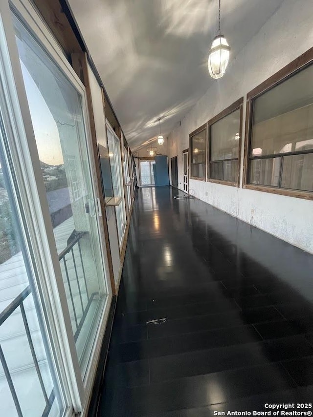 hallway featuring wood-type flooring and lofted ceiling