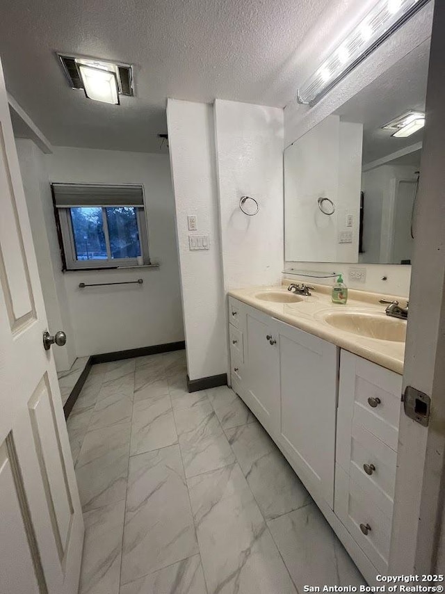 bathroom featuring vanity and a textured ceiling