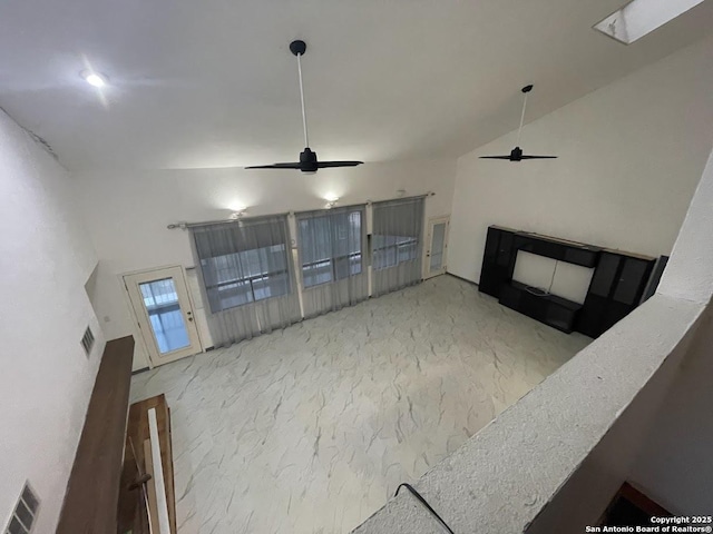 unfurnished living room with high vaulted ceiling and ceiling fan