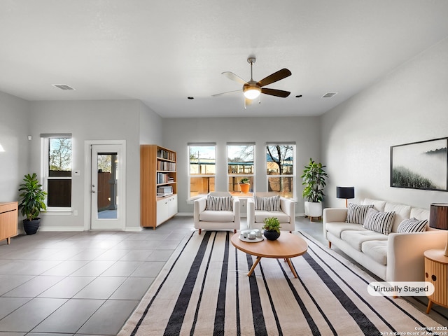 living room with ceiling fan and light tile patterned floors