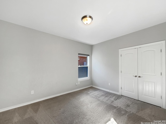 unfurnished bedroom featuring carpet flooring and a closet