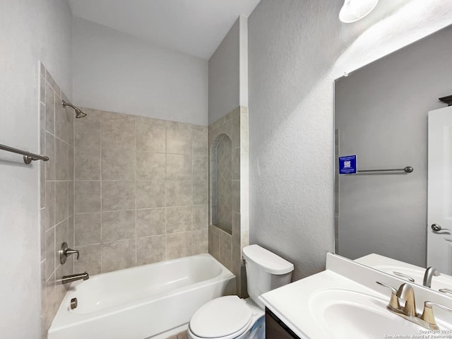 full bathroom with tiled shower / bath, vanity, and toilet