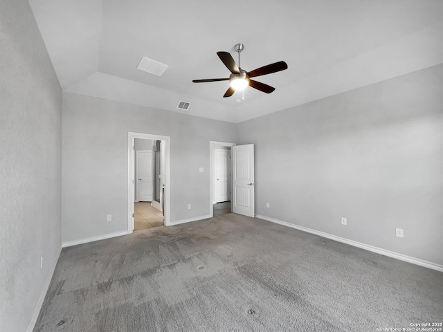 unfurnished bedroom featuring ensuite bathroom, light colored carpet, and ceiling fan