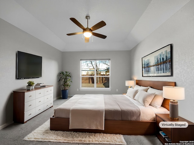 carpeted bedroom featuring lofted ceiling and ceiling fan