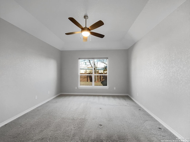 carpeted empty room with vaulted ceiling and ceiling fan