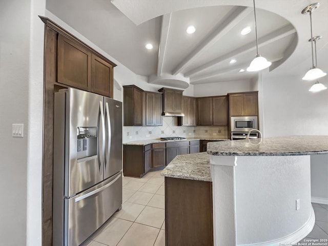 kitchen featuring stainless steel appliances, dark brown cabinets, pendant lighting, and decorative backsplash