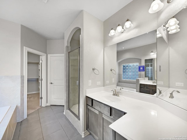 bathroom with vanity, tile patterned floors, and shower with separate bathtub