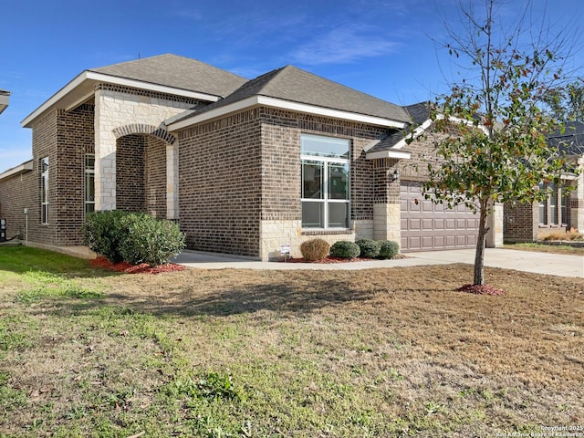 view of side of home featuring a garage and a lawn