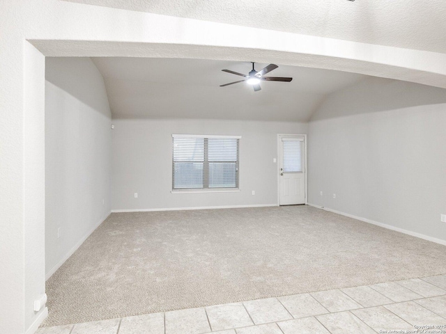 carpeted empty room featuring lofted ceiling and ceiling fan