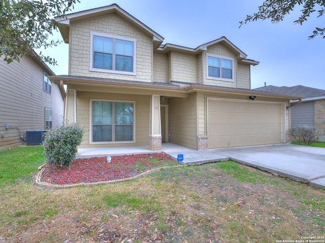 view of front facade with concrete driveway, a front lawn, an attached garage, and central air condition unit