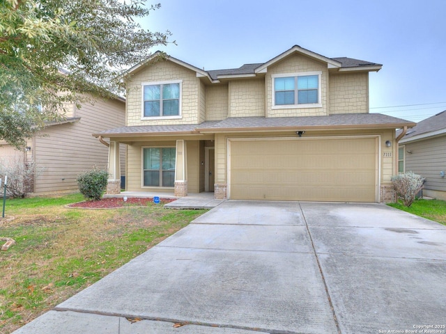 view of front of property with a garage and a front yard