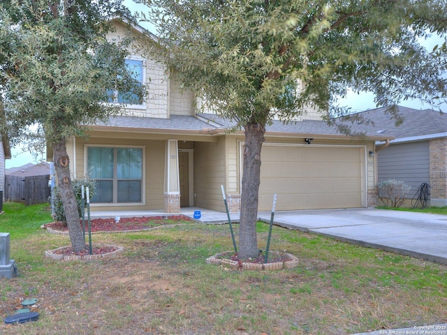 view of front of property with a garage and a front lawn