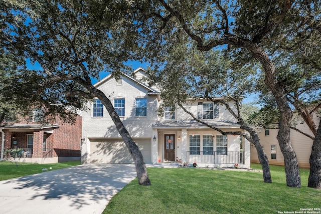 view of front of home featuring a porch, a garage, and a front lawn