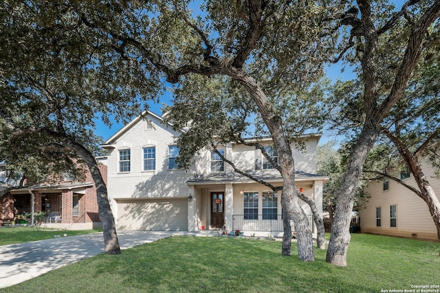 view of front of home featuring a garage, a front lawn, and covered porch