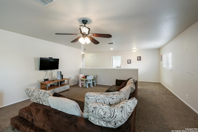 living room with ceiling fan and dark carpet