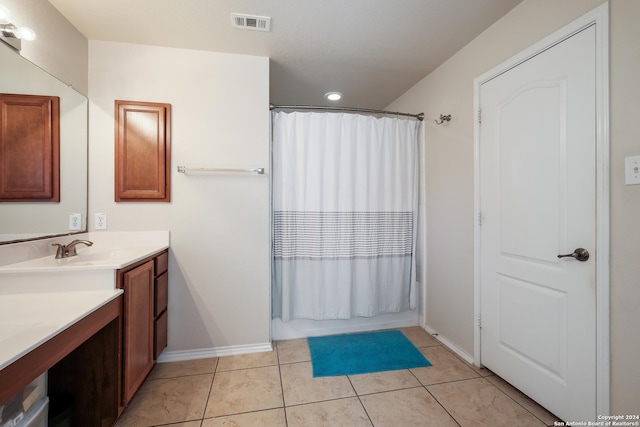 bathroom with tile patterned floors, vanity, and shower / tub combo