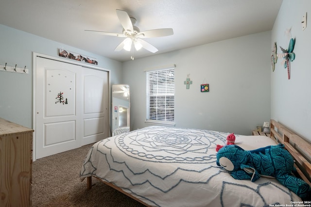 carpeted bedroom with ceiling fan and a closet