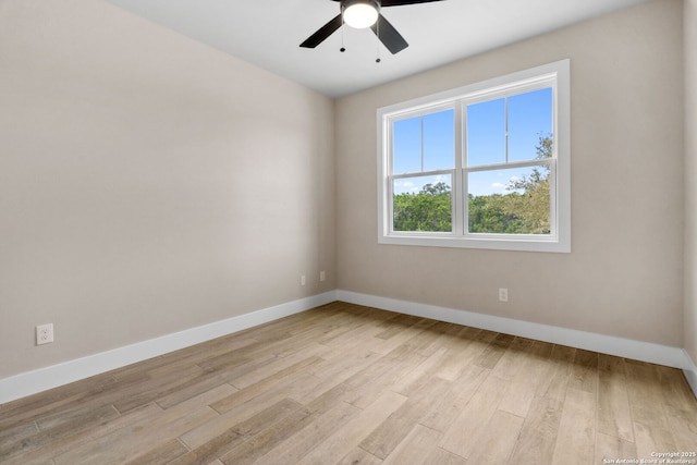 empty room with ceiling fan and light hardwood / wood-style floors