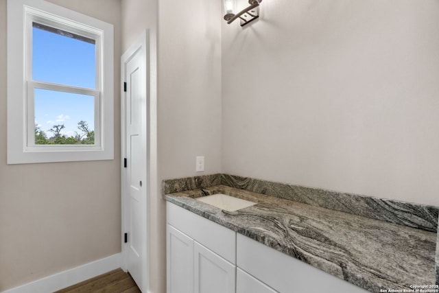 bathroom with vanity and wood-type flooring