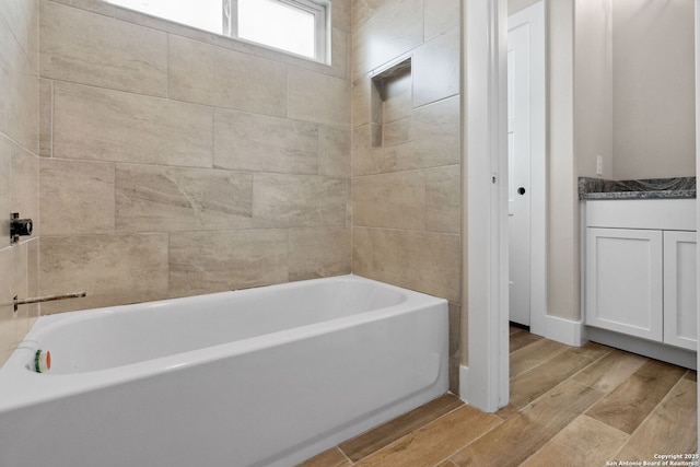 bathroom with vanity and a bathtub