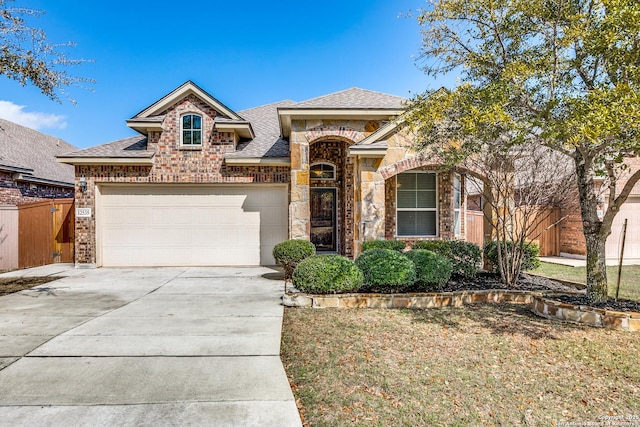 view of front of property featuring a garage and a front lawn