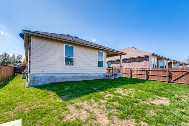 rear view of house with a yard