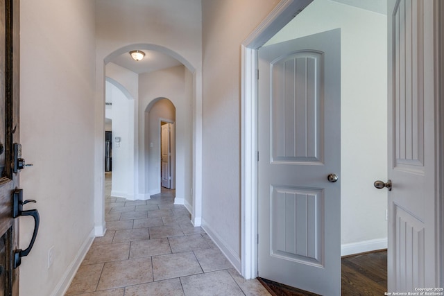 corridor featuring light tile patterned floors