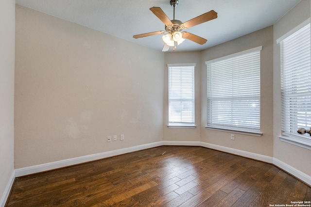 spare room featuring ceiling fan and dark hardwood / wood-style flooring