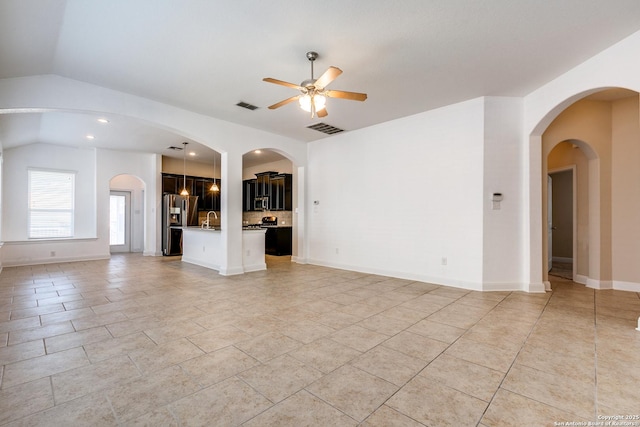 unfurnished living room with light tile patterned flooring, ceiling fan, lofted ceiling, and sink