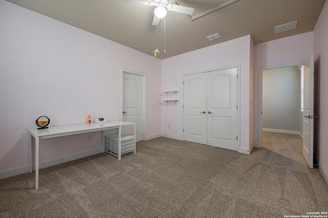 interior space featuring light carpet, ceiling fan, and a closet