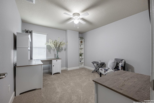 carpeted office with ceiling fan and a textured ceiling