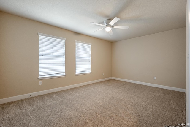 carpeted spare room with ceiling fan and a textured ceiling