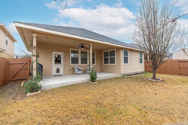 rear view of house with a yard, a patio, and ceiling fan