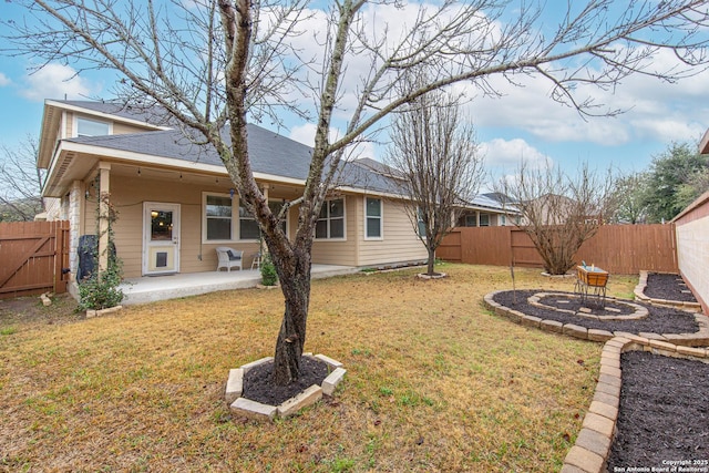 back of house featuring a patio and a lawn