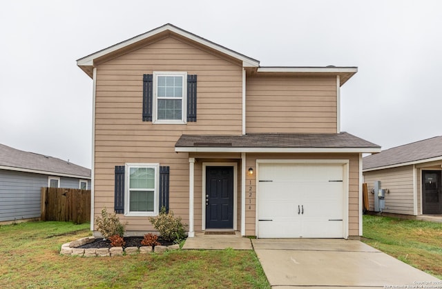 view of front of house with a garage and a front lawn