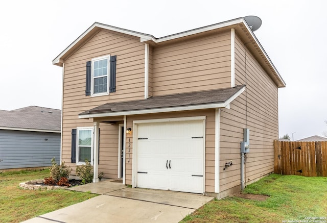 view of front property featuring a garage and a front lawn