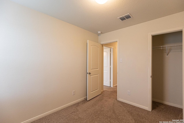 unfurnished bedroom with a closet and carpet