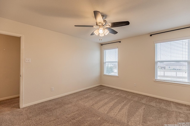 carpeted spare room featuring ceiling fan