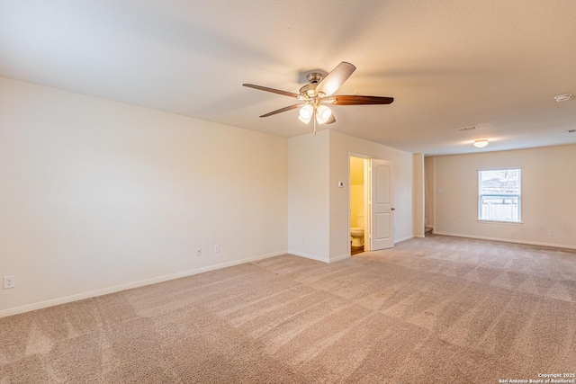 unfurnished room featuring light colored carpet and ceiling fan