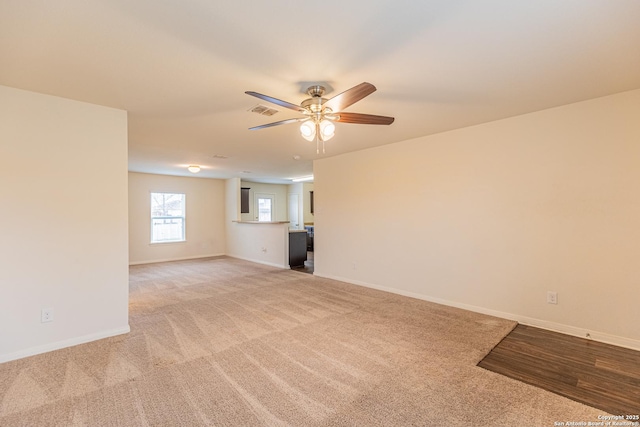 unfurnished living room with ceiling fan and light colored carpet